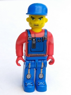 Tractor Driver With Blue Overalls, Red Shirt, Plain Blue Cap, Beard Stubble